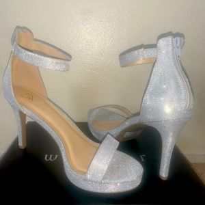 Sparkly, silver, heel, size “8” material is “SVGM”